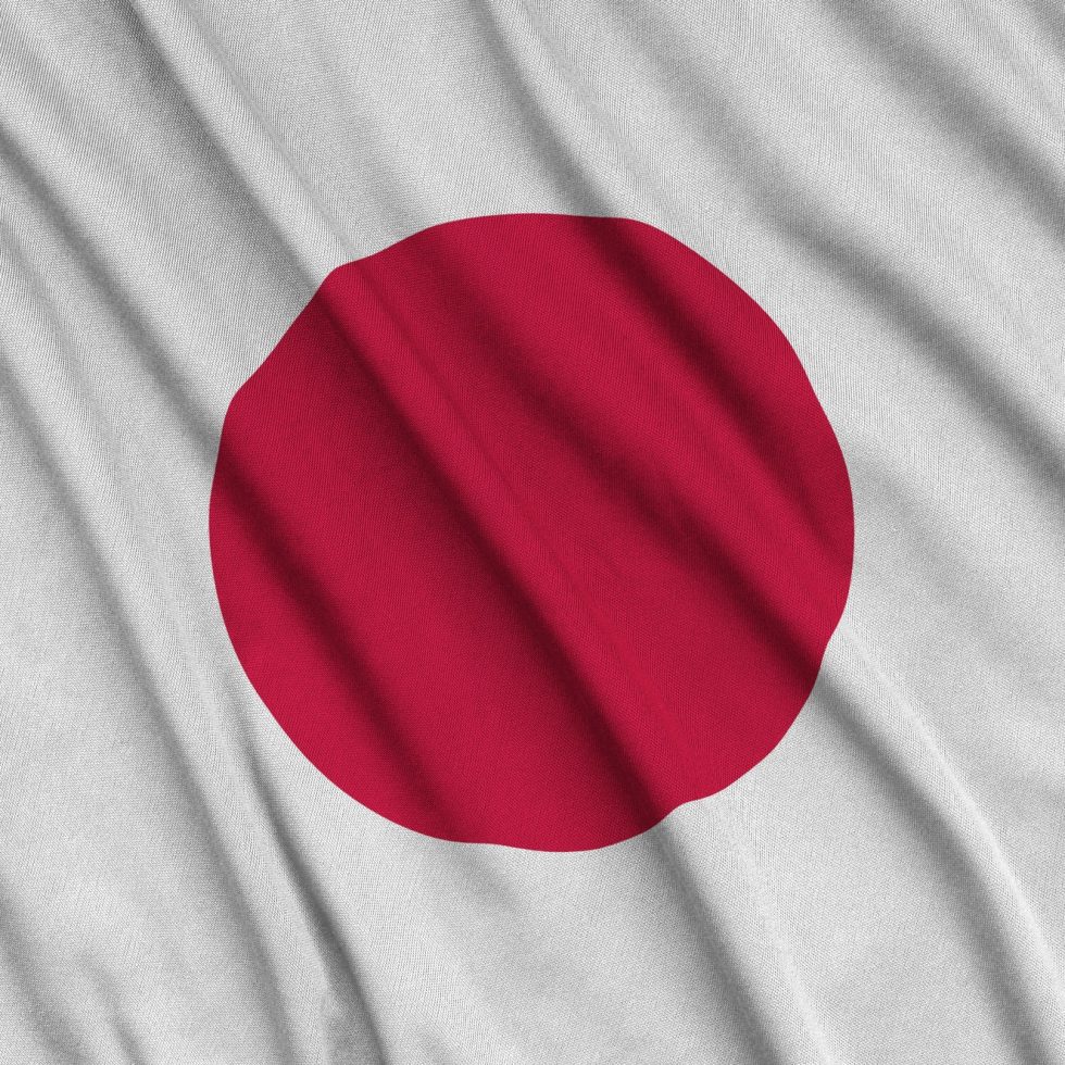 japan-flag-is-depicted-on-a-sports-cloth-fabric-with-many-folds-sport-team-waving-banner.jpg